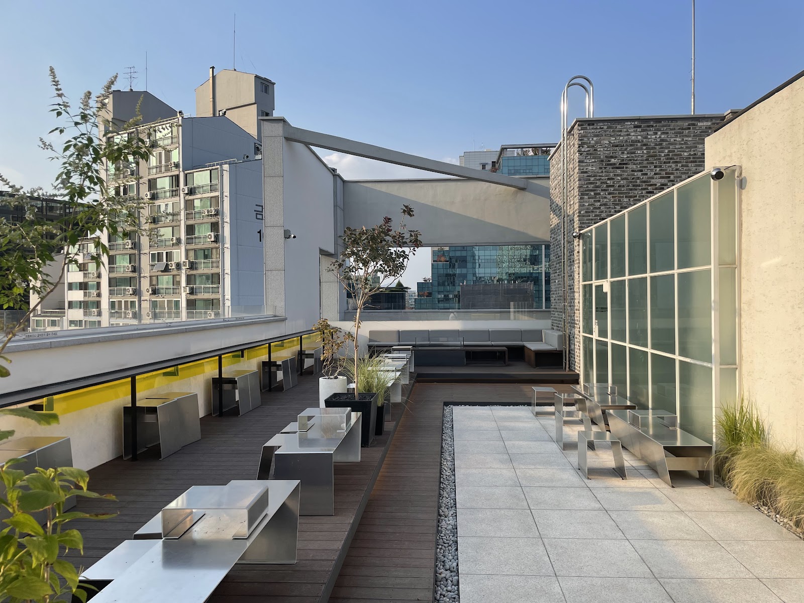 Seongsu industrial street — converted warehouse facades with brick, steel, and foliage